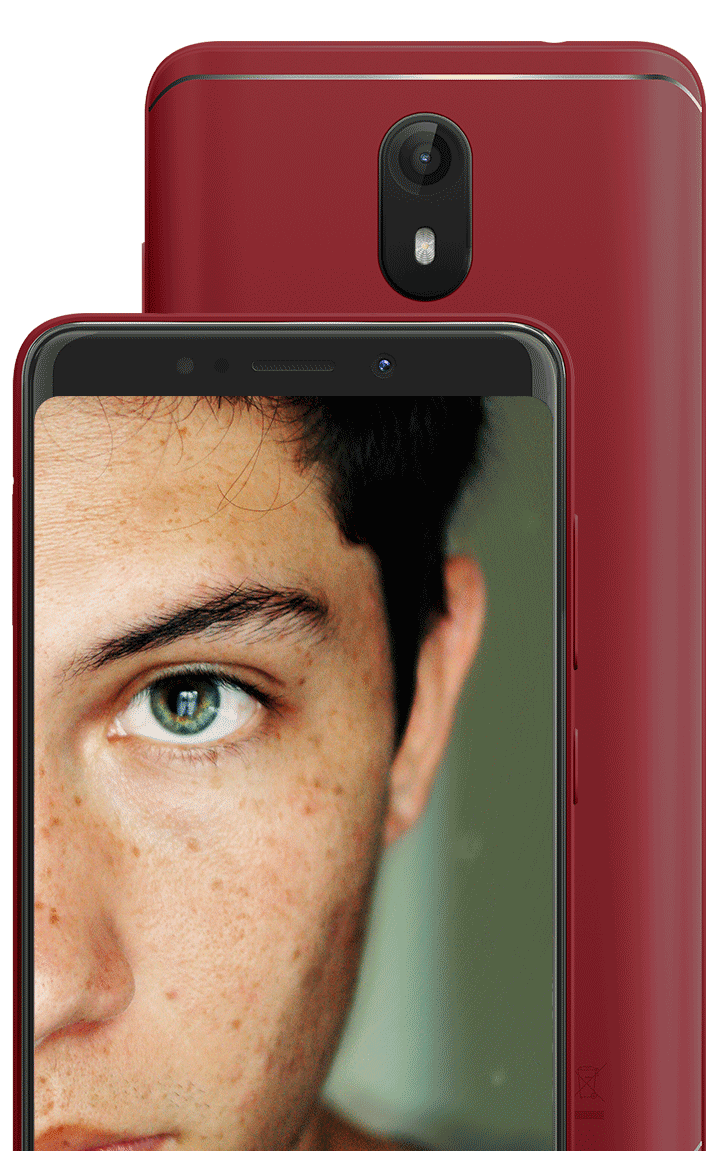 A selfie portrait of a guy with the see in background